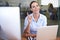 Finding business solutions online. Portrait of a young businesswoman sitting at her desk and working on her computer.