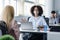 Finding customers and employees after lockdown. African american woman in protective mask at desk with antiseptic and