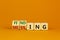 Finding or missing symbol. Turned wooden cubes and changed the word missing to finding. Beautiful orange background. Business,