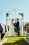 Finding that someone special. a cheerful young bride and groom holding each others hands at the wedding alter outside