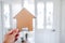 finding your dream property and real estate market value, cardboard house in front of entry door bokeh with led light