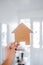 finding your dream property and real estate market value, cardboard house in front of entry door bokeh with led light
