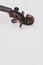 fine acoustic violin scroll with pegs on a white background