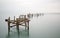 Fine art landscape image of derelict pier in milky long exposure