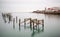 Fine art landscape image of derelict pier in milky long exposure