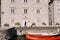 Fine-art wedding photo in Montenegro, Perast. The bride and groom are dancing against the backdrop of an old white house