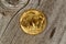 Fine gold Buffalo Coin on rustic wooden background