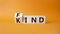 Fine and Kind symbol. Wooden cubes with words Kind and Find. Beautiful orange background. Business and Fine and Kind concept. Copy