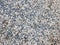 Fine pebbles of a gray shade. Beach ground. Natural material for design, decoration and construction. Sanded granite and hard