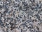 Fine pebbles of a gray shade. Beach ground. Natural material for design, decoration and construction. Sanded granite and hard mine