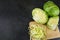 Finely chopped cabbage on a chopping board And cauliflower on black ground