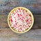 Finely chopped crab sticks in a bowl on old wooden table