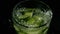 Finely chopped cucumber falls into a glass. Slow mo