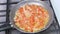 Finely chopped onion frying with tomatoes.