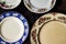 Finely decorated antique dishes on black background. Free space to write