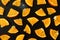 Finely sliced tangerines on a wet black background