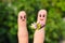Finger art of couple. man gives woman flowers, she is not satisfied.