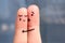 Finger art of displeased couple. Woman cries, man reassures her.