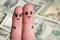 Finger art of a Happy couple. A man and a woman hug on the background of money