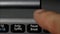 A finger hitting pause button on notebook keyboard