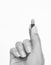 Finger holds pill on white background, Black and white tone