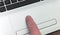 Finger on laptop touchpad