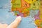 Finger pointing to a colorful country map in English and French Ivory Coast Cote D`Ivoire