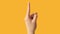 Finger pointing up attention gesture hand orange