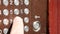 Finger presses aluminum intercom buttons. Man hand enters a code to open door