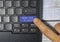 Finger pressing blue keyboard labeled online class