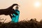 Finger pressing a bottle of gel backlit on straw