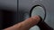 Finger pressing button of electronic plate. Household utensils. Close-up of man pressing large round button on plate