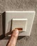 Finger pressing a dirty switch or door bell with a lot of germs. Clean and health care concept