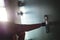 Finger pressing doorbell in apartment building corridor