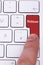 Finger pressing on red webinar button on metallic keyboard