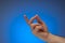 Finger snap gesture by Caucasian male hand. Close up studio shot, isolated on blue background