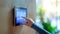 A finger touching the sleek digital interface adjusting the temperature, Smart home concepts, generated ai