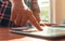 Finger touching tablet in meeting desk