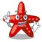 Finger toy red starfish cartoon above table