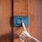 Finger turn on or off on light switch on wall at home. Energy Saving, power, electrical and lifestyle concepts