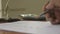 Finger writing doing calculation. Calculating balance Audit or tax report with calculator. Close-up Defocused front Businessman