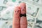 Fingers art of couple on background of money.