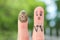 Fingers art of couple. Husband saw his wife with clay face mask and was afraid