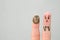 Fingers art of couple. Husband saw his wife with clay face mask and was afraid