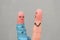 Fingers art of couple with meter. Concept husband is angry that his wife can not lose weight