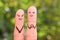 Fingers art of happy couple. Boyfriend showing fingers in heart shape.