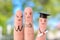 Fingers art of happy family. Concept parents are proud of their child graduated from college