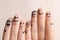 Fingers with drawings of happy faces