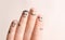 Fingers with drawings of happy faces