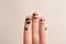 Fingers with drawings of happy faces